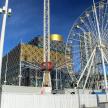 a ferris wheel in front of a building and a building