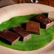 a plate of chocolate desserts on a green leaf