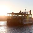 a ferry boat on the water at sunset