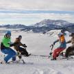 a group of people on skis on top of a mountain