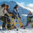 a group of people on a ski lift in the snow