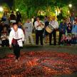 a man is walking through a circle of red confetti