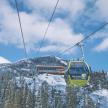 a ski lift going up a snowy mountain