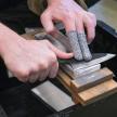 a person holding a knife on a cutting board