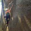 a woman is climbing on a rock wall