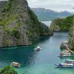 a group of boats in a river with cliffs