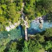 an overhead view of a river with trees and water