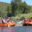 a group of people in rafts on a river