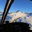 a view of a snow covered mountain from a helicopter