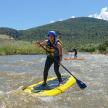 a person riding a paddle board on a river
