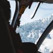 a person is looking out the window of a helicopter