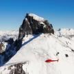 a snow covered mountain with a red object on it