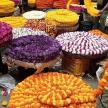 a bunch of different colored hats in a market