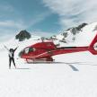 a man standing next to a red helicopter in the snow