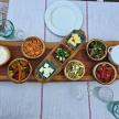 a wooden tray with different types of food on a table