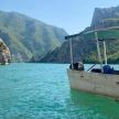 a boat in the water with mountains in the background
