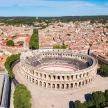an aerial view of a city with a large amphitheater