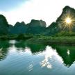 a boat on a river with mountains in the background