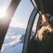 a woman is looking out the window of an airplane