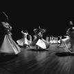 a group of people dancing on a wooden floor