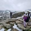 a group of people standing on top of a mountain