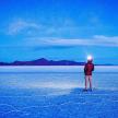 a man standing on a frozen lake at night