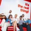 a group of people sitting on a red couch