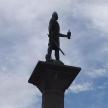 a statue of a man with a spear and a bird