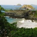a view of a beach with rocks and the ocean