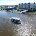 a small boat in the water in a marina