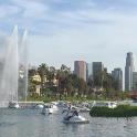 a group of boats in the water with a fountain