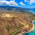 an aerial view of a mountain next to the ocean