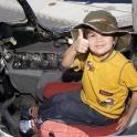 a young boy is sitting in the cockpit of an airplane