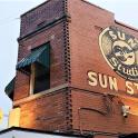 a brick building with a sun studio sign on it