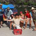 a group of people posing in front of a boat