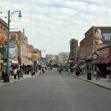 a city street with people walking down the street