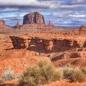 a view of the desert with large rock formations
