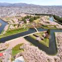 an aerial view of a park with a river