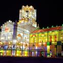 a lit up building with a clock tower at night