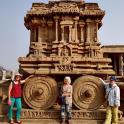 a group of people standing in front of a stone building