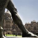 a statue in front of a large building