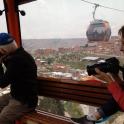 a woman taking a picture of a man in a gondola
