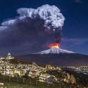 a eruption of a volcano at night with flames and smoke