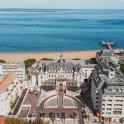 an aerial view of a building next to a beach