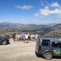 a group of people standing on the top of a mountain