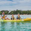 a man and two children in a yellow kayak in the water
