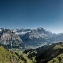 people on a suspension bridge over a mountain valley