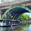 a boat on a river under a bridge