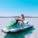 a girl sitting on a jet ski in the water