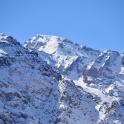 a snow covered mountain with a blue sky